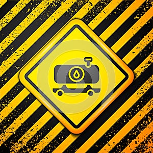 Black Fuel tanker truck icon isolated on yellow background. Gasoline tanker. Warning sign. Vector