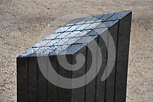 Black gabbro stone prism. it stands in the park and is bevelled and polished. if it gets wet, can play various sound melodies and