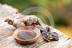 Black galingale rhizome ,dried slices and powders on nature background