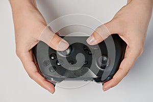 Black game controller in hand