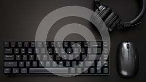 Black gaming computer keyboard, headphones and computer mouse on a dark background. Wireless technology and gadgets. Copy space