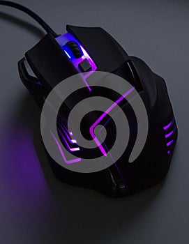 A black gaming mouse with a purple light