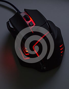A black gaming mouse with a red light