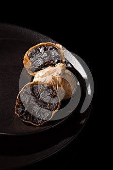 Black garlic on black plate