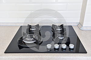 Black gas cooker installed in the kitchen on the countertop