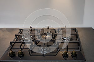 Black gas cooker, photo of kitchen equipment with selective focus