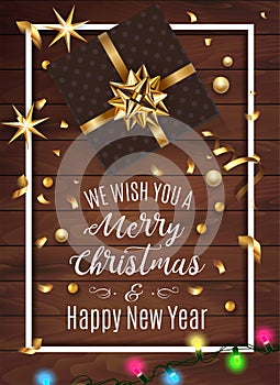 Black gift box with a beautiful gold bow on wooden background. Merry Christmas and Happy New Year greeting card. Vintage