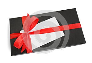 Black gift box with red satin ribbon bow and a blank card
