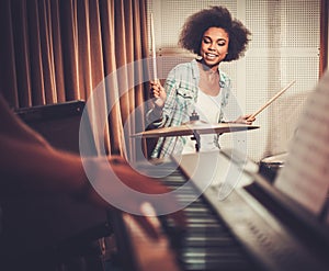 Black girl behind drums on a rehearsal