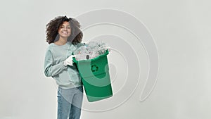 Black girl holding dustbin with plastic garbage