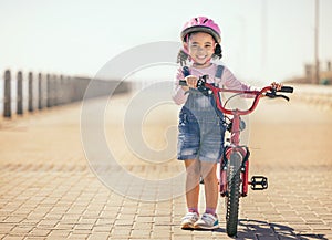 Black girl, learning and bike for portrait, smile or park path with sunshine, safety or happiness. Kid, happy and