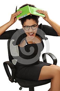 black girl in office chair in panic covers the head with a notebook