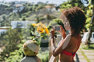 Black girl taking pics on the beach