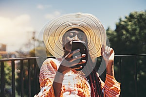 Black girl using phone outdoors photo