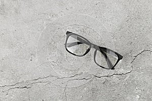 Black glasses on concrete background. Two pairs of 3d glasses on a gray concrete background. Top view, copy space. Two pairs of 3d