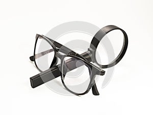 Black glasses and magnifying glass isolated on white background. with clipping path