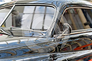 Black and glossy retro car, close-up. side view