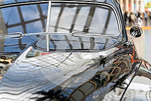 Black and glossy retro car, close-up. View of the windshield