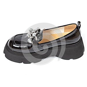 Black glossy women's ankle boots with beige leather insole and round toe decorated with shiny crystals on a thick