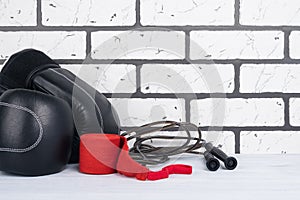 Black gloves with jumpers and protective red bandages on the gym floor