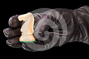 Black gloves and white chess knight