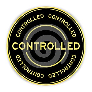 Black and gold round sticker with word controlled on white background