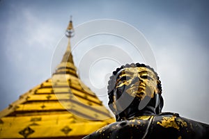 Black and gold statue of Buddha in Doi Suthep