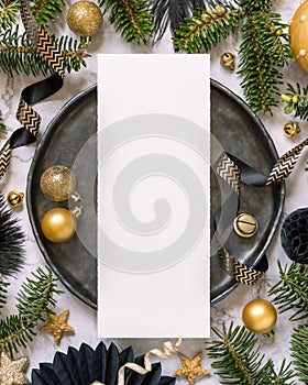 Black and golden Christmas Table setting with ornaments and fir tree branches. Menu card Mockup