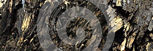 Black , golden rocks - abstract volcanic stone background