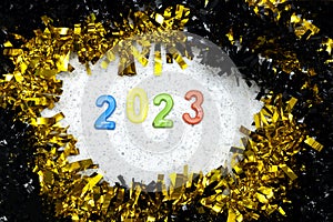 Black and golden Tinsel with Border Frame around 2023 happy new year