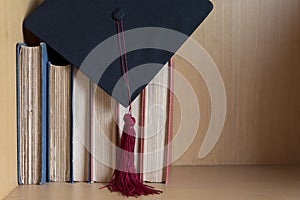 Black graduated cap and red tassel