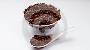 white rice in spoon and bowl isolated on black background