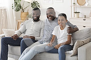 Black Grandfather With Son And Grandson Relaxing Together At Home