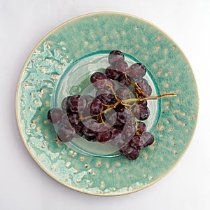 Black Grapes on Celadon Blue Plate
