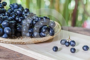 Black grapes on wooden