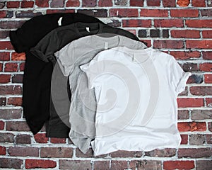 Black, Gray, and White t shirt mockup on brick background