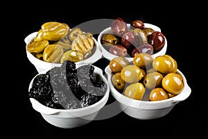 Black, green, grilled, and pink olives in bowls