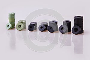 Black and green hydraulic and pneumatic o-ring seals of different sizes stacked on a white background