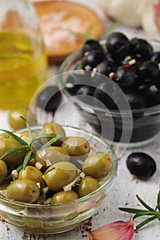 Black and green olives in glass bowls photo