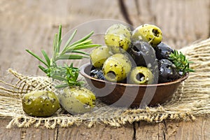 Black and green olives marinated with garlic and fresh mediterra