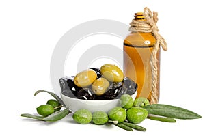 Black and green olives mixed in the porcelain bowl and Virgin olive oil