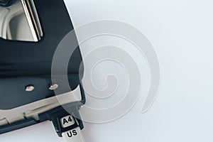 Black and grey office paper hole puncher on white background