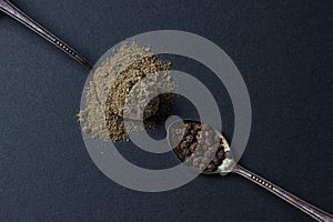 Black ground pepper and peppercorns on a black background