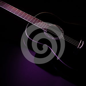 Black guitar against a dark background, isometric view. guitar music low-key concept