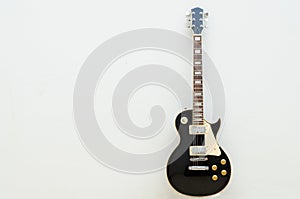 Black guitar model les paul on a totally white background showing the whole body