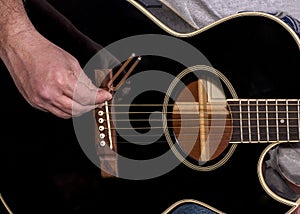 Black guitar and tuning fork