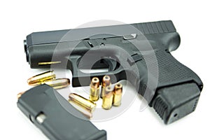 Black gun and 9mm bullets a white background