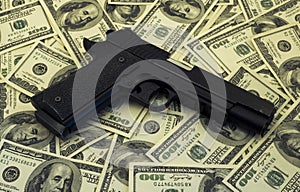 Black gun pistol and money dollars background filtered