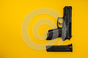 Black gun on a yellow background