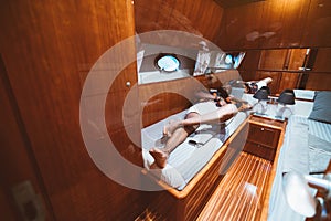 Black guy on a bed in a yacht cabin